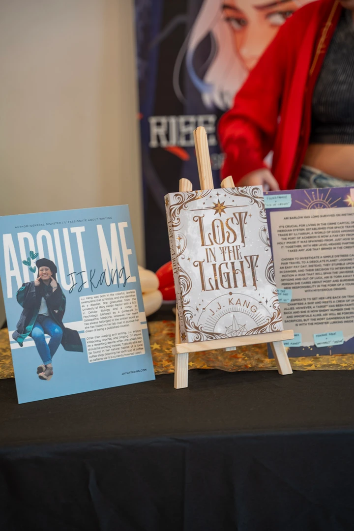 Books and author information displayed at a stall.
