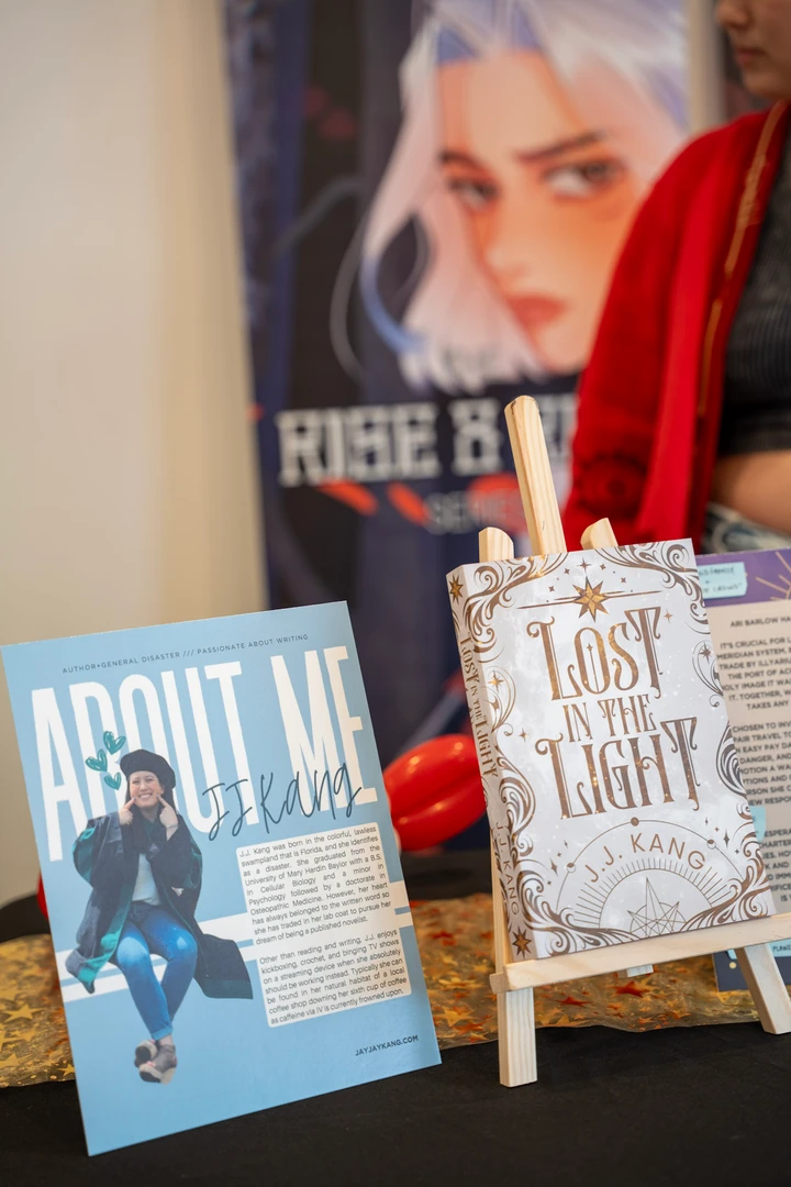 Books and author information displayed at a stall.