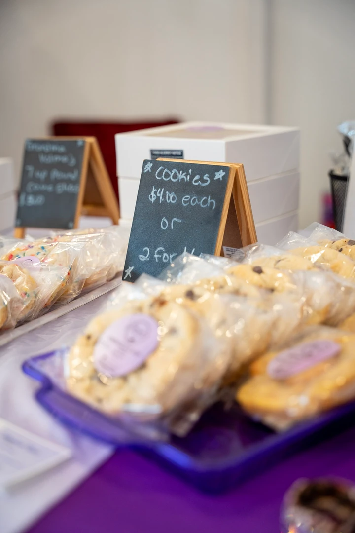 Packaged cookies arranged on a purple table runner.