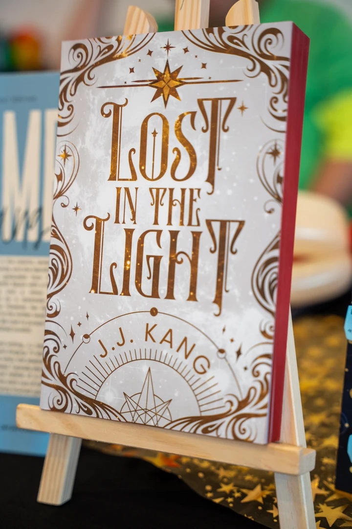An ornate illustrated book cover on a stand.