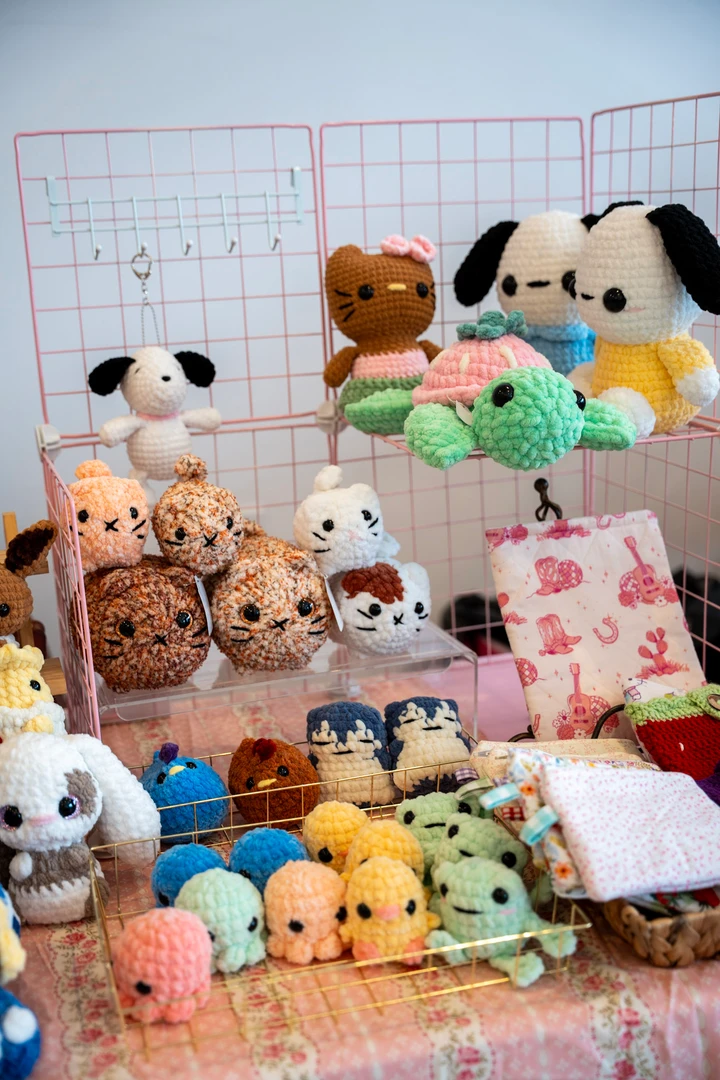 Colorful crocheted animals arranged across a craft table.