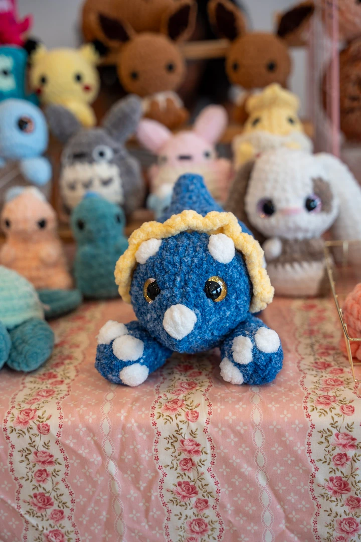 Colorful crocheted animals arranged across a craft table.