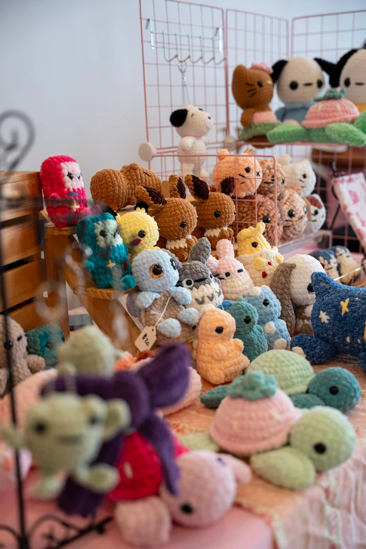 Colorful crocheted animals arranged across a craft table.