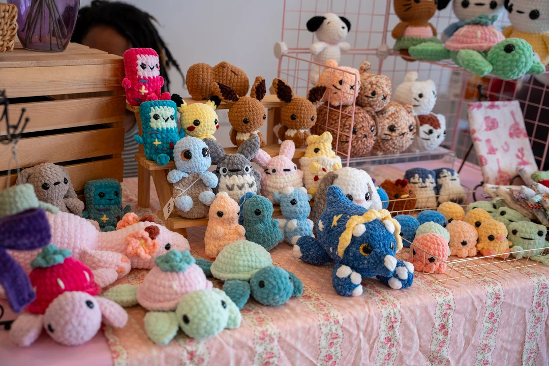Colorful crocheted animals arranged across a craft table.