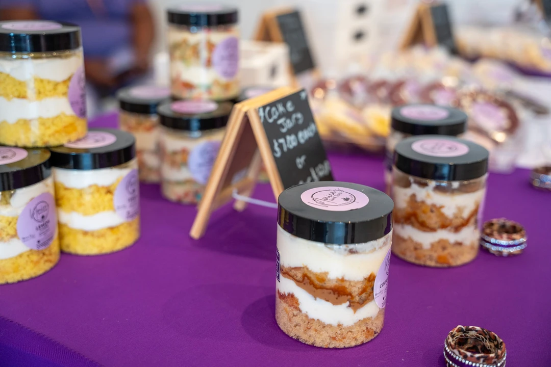 Labeled dessert jars on a purple table runner.