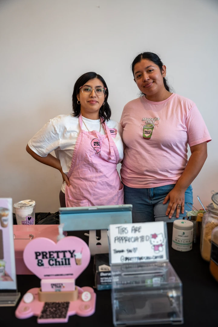 Two makers behind a pink Pretty & Chill display.