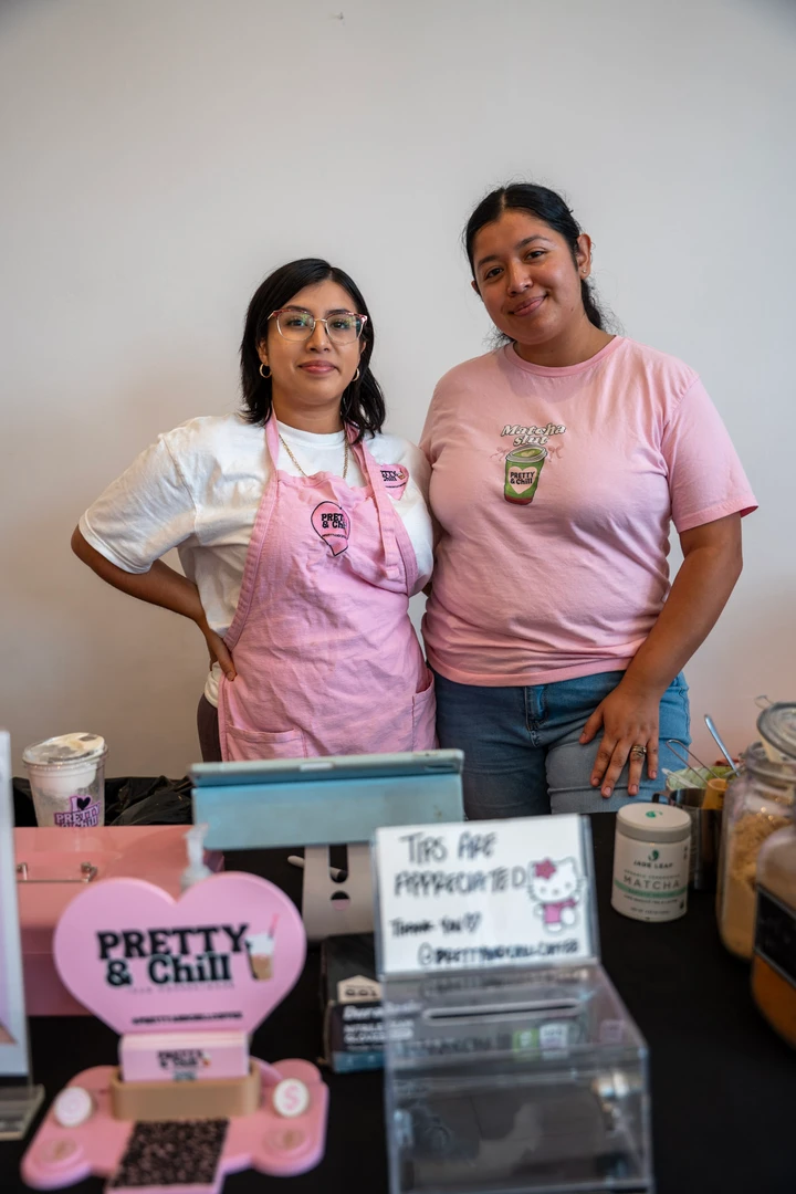 Two makers behind a pink Pretty & Chill display.