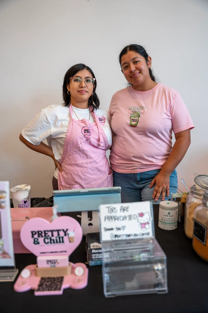 Two makers behind a pink Pretty & Chill display.