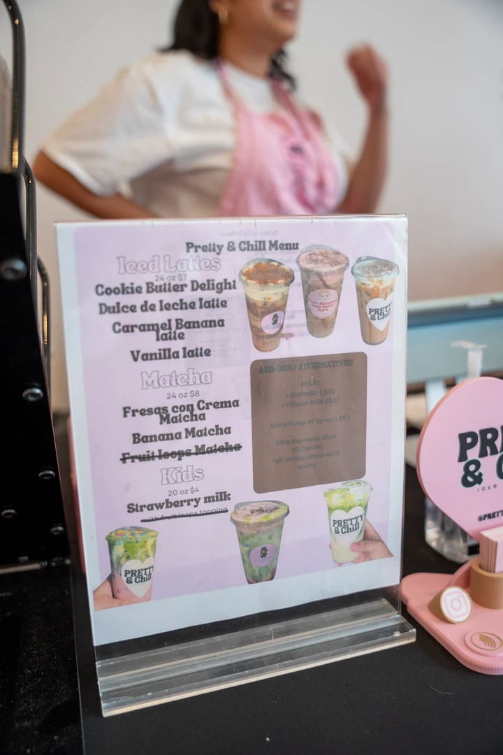 A small menu and information cards on a pink display.