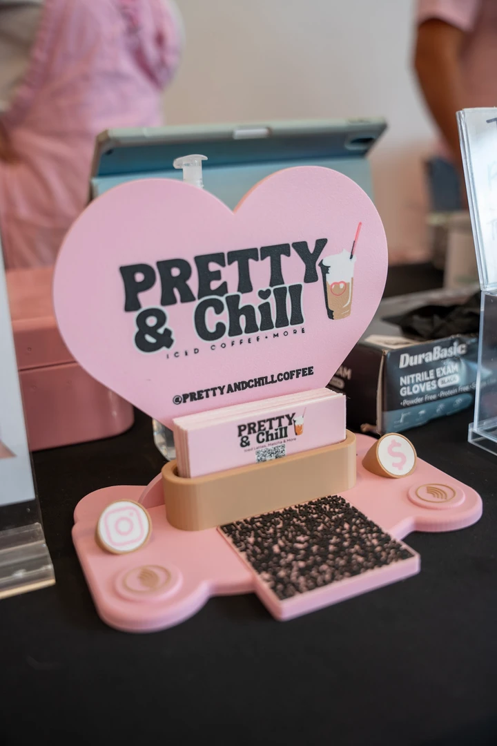 A Pretty & Chill sign and small items on a tabletop display.
