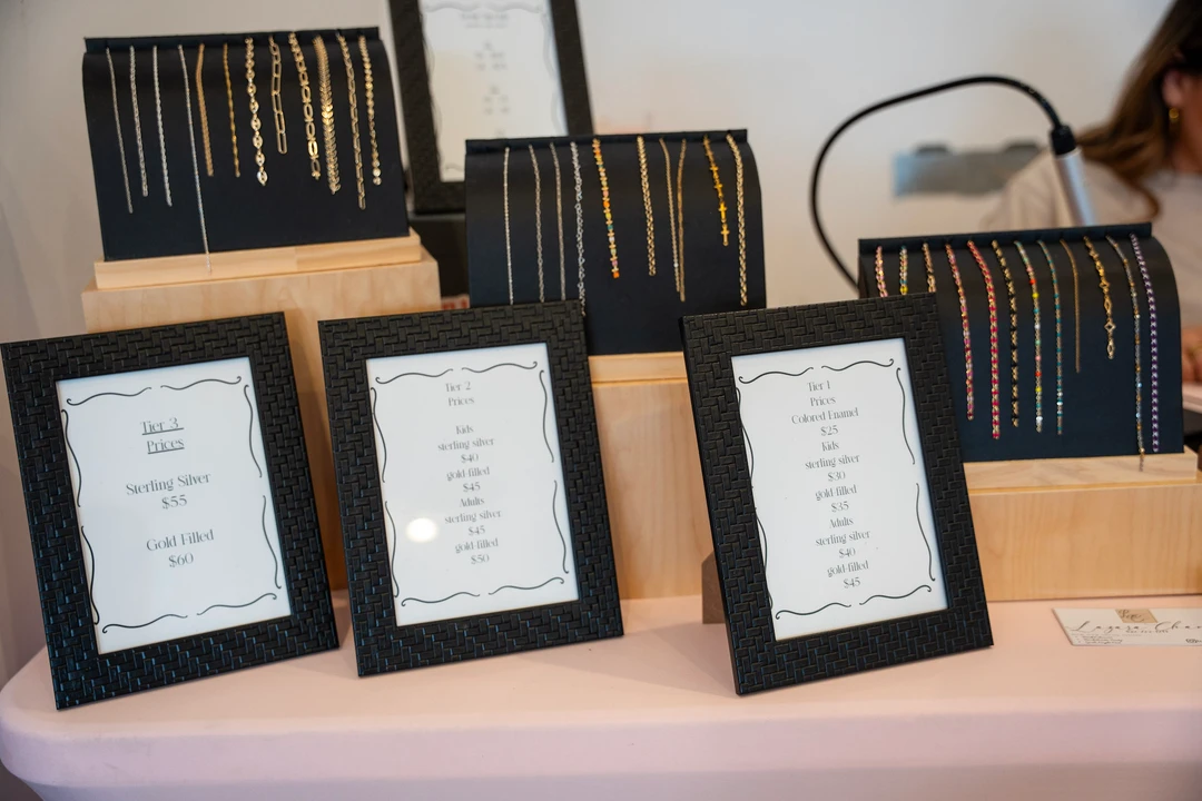 Framed pieces and paper goods arranged on a display table.