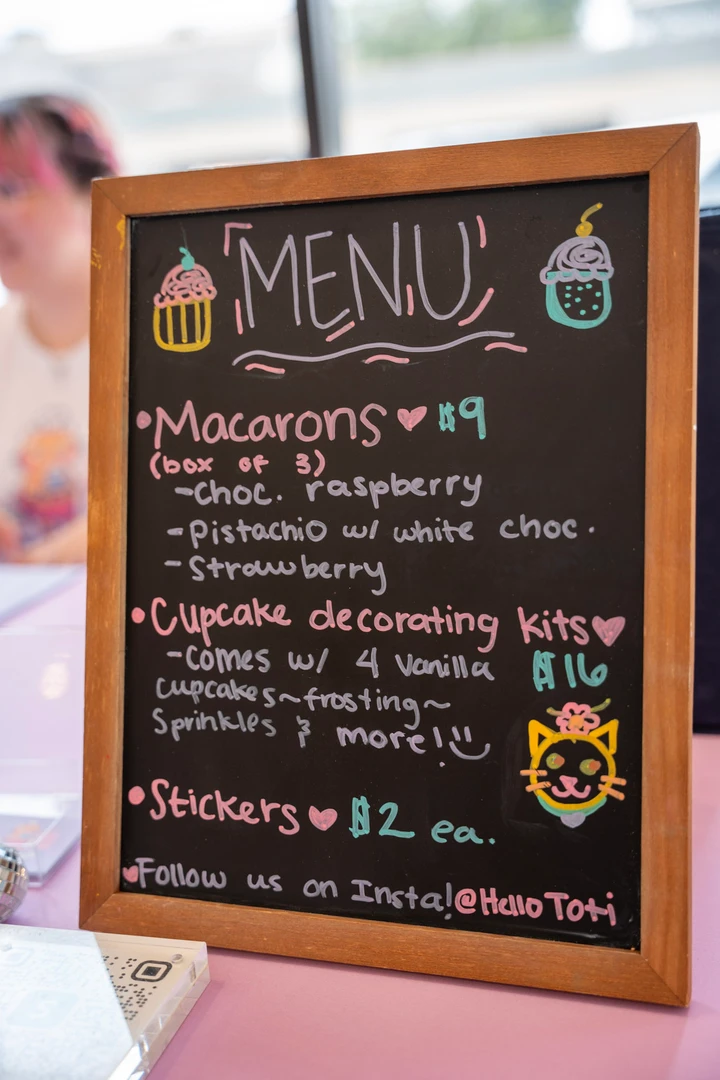 A handwritten macaron menu on a small chalkboard.