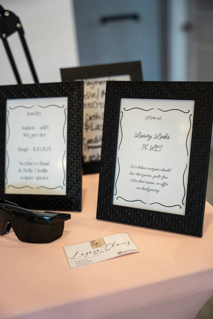 Framed pieces and paper goods arranged on a display table.