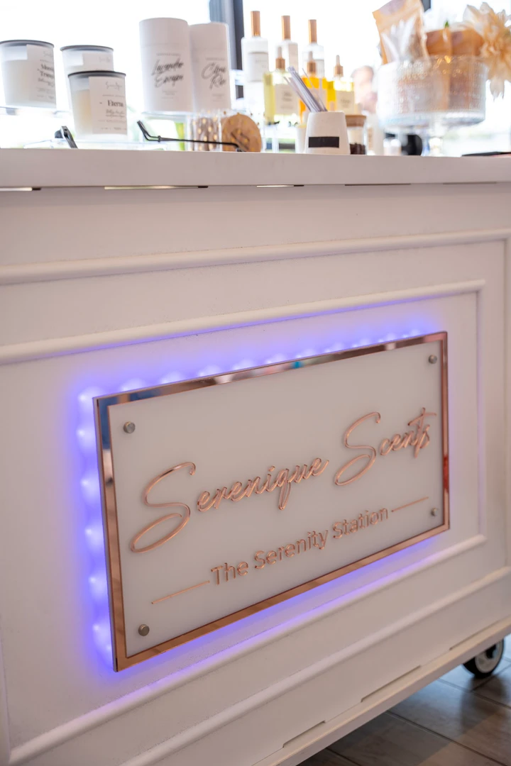 A pink sign on the front of a beauty-product table.