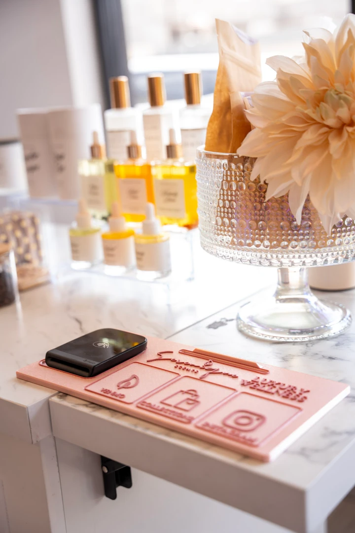 Beauty products and information cards arranged by a window.