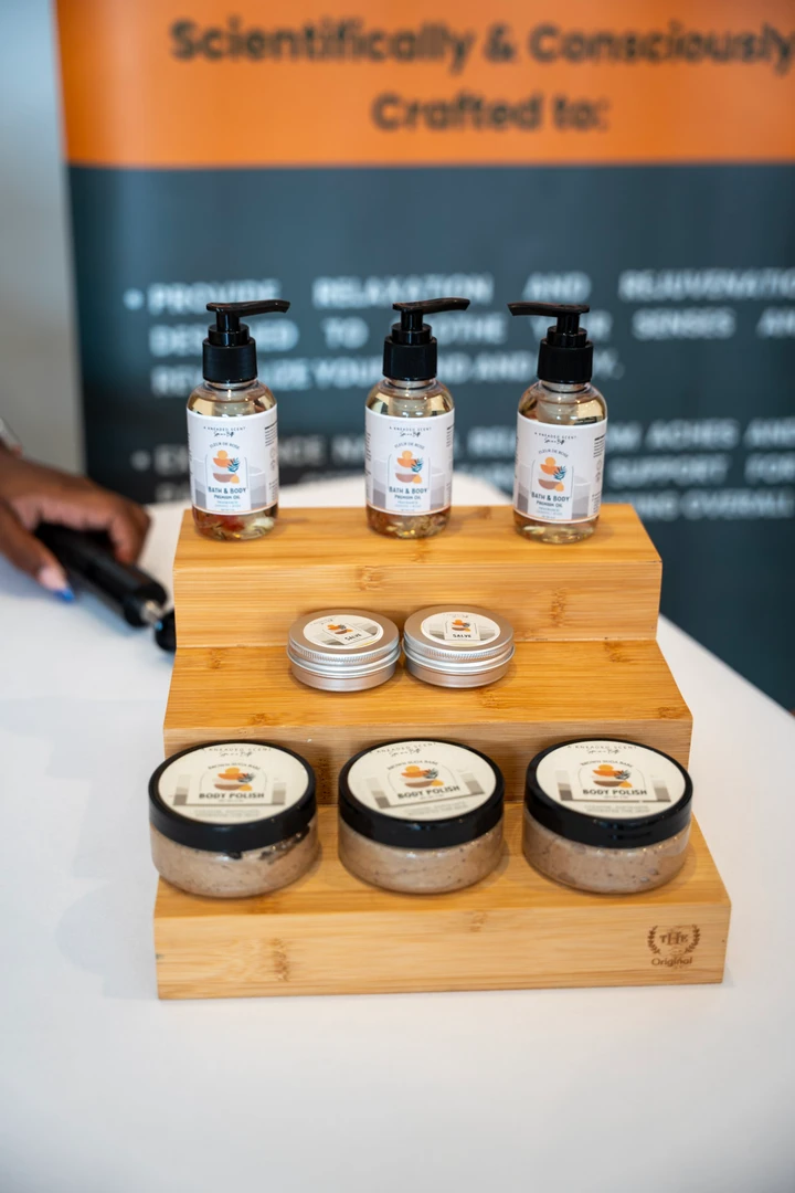 Skincare jars and bottles on a stepped wooden display.