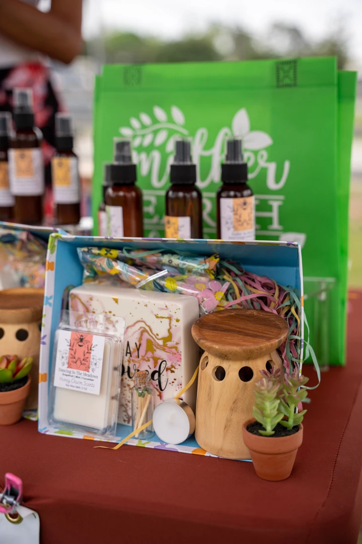 Colorful candles, bottles and ceramic containers on a display table.