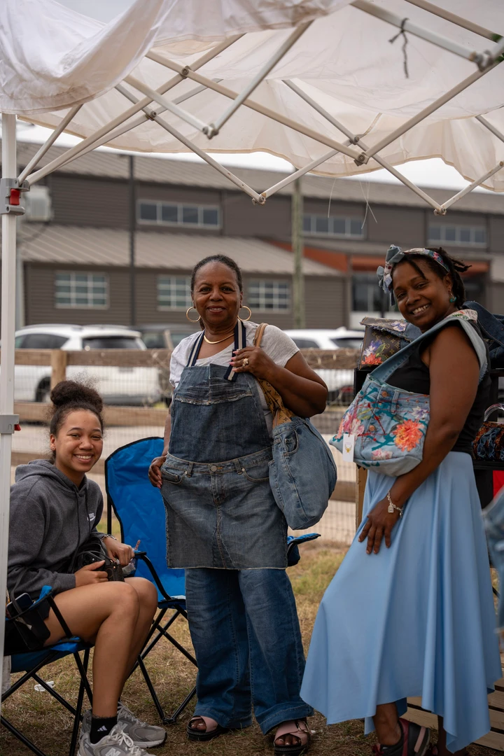 Friends gathering beside the outdoor market stalls.
