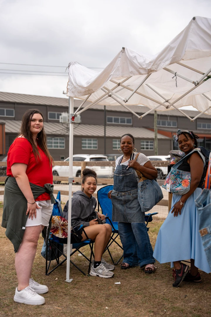 Friends gathering beside the outdoor market stalls.