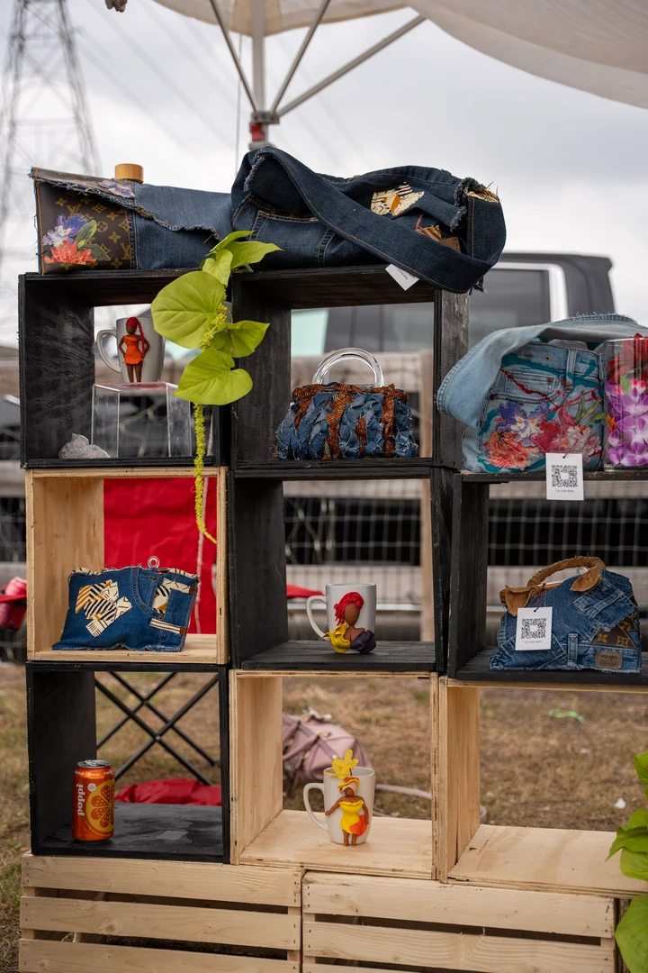 Colorful goods and plants arranged on wooden market shelves.