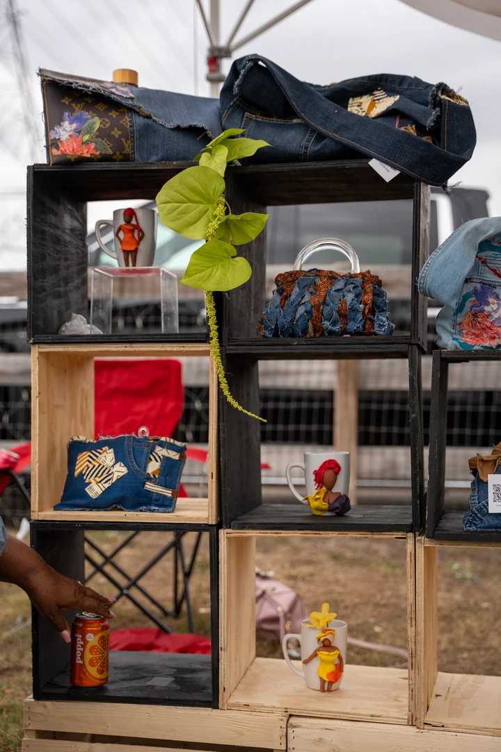 Colorful goods and plants arranged on wooden market shelves.