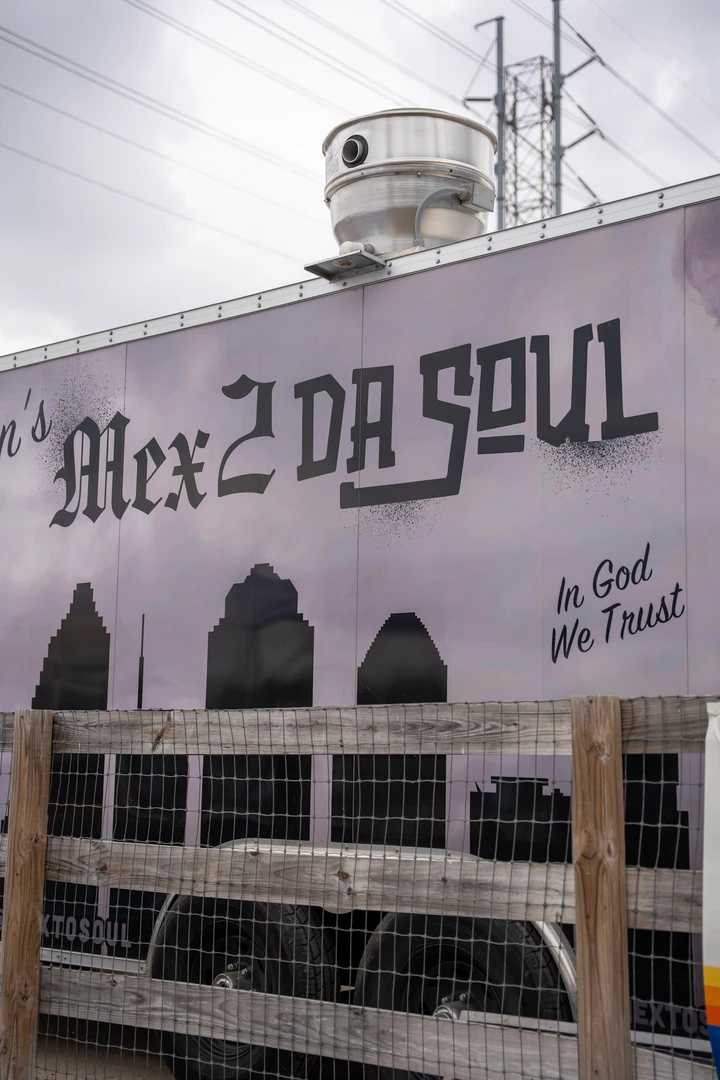 A Mex2DaSoul banner beside a market stall.