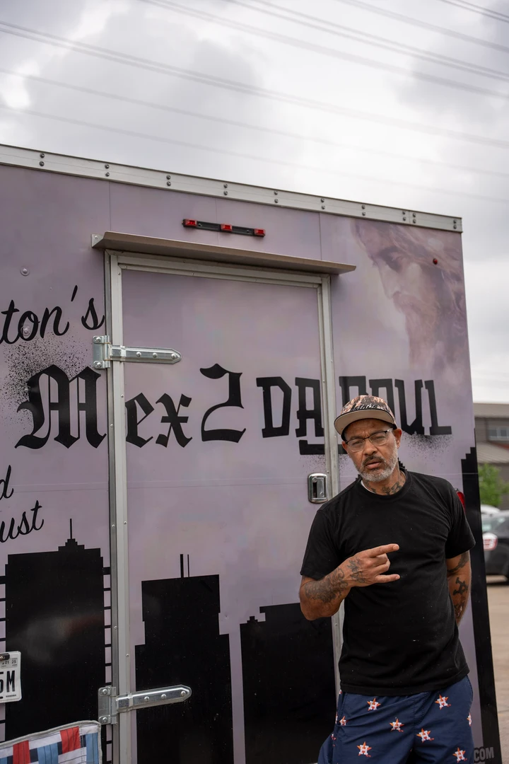 A vendor standing in front of the Mex2DaSoul banner.