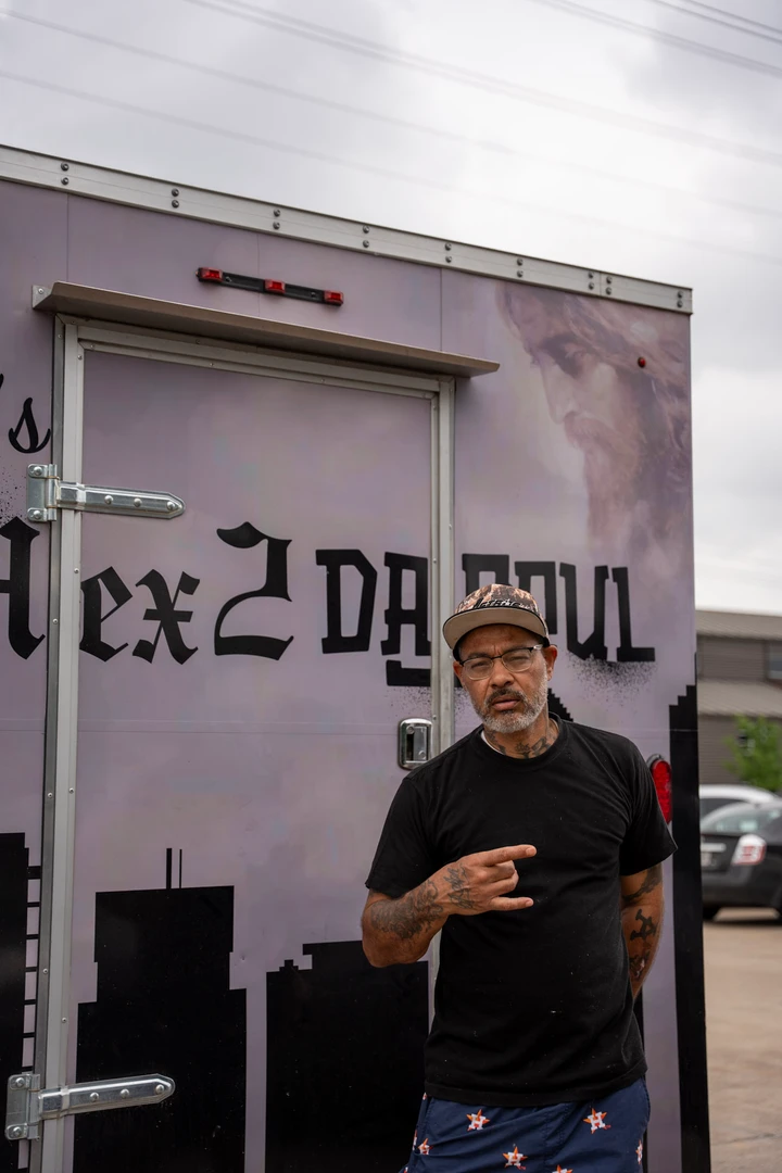 A vendor standing in front of the Mex2DaSoul banner.