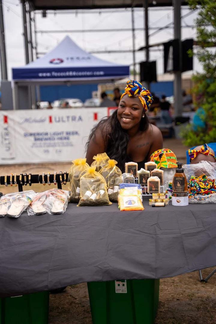 Candles and wrapped gifts arranged on a market table.