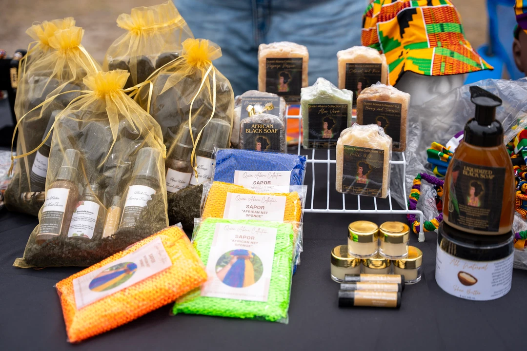 Candles and wrapped gifts arranged on a market table.