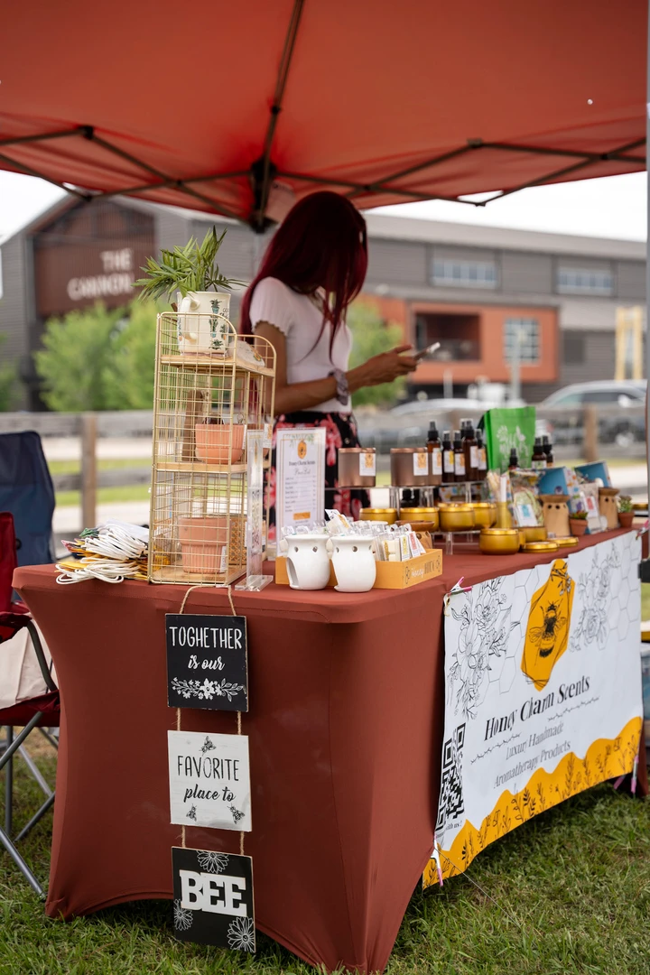 The Honey Charm Scents stall beneath a red canopy.