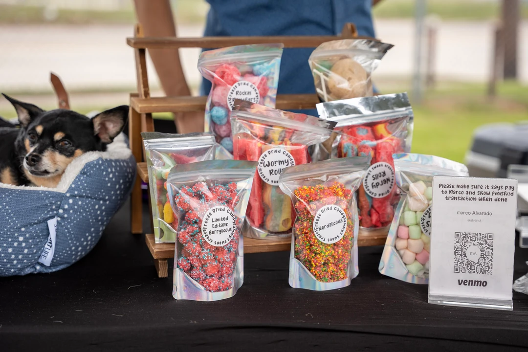Bags and containers of colorful candy on a market table.