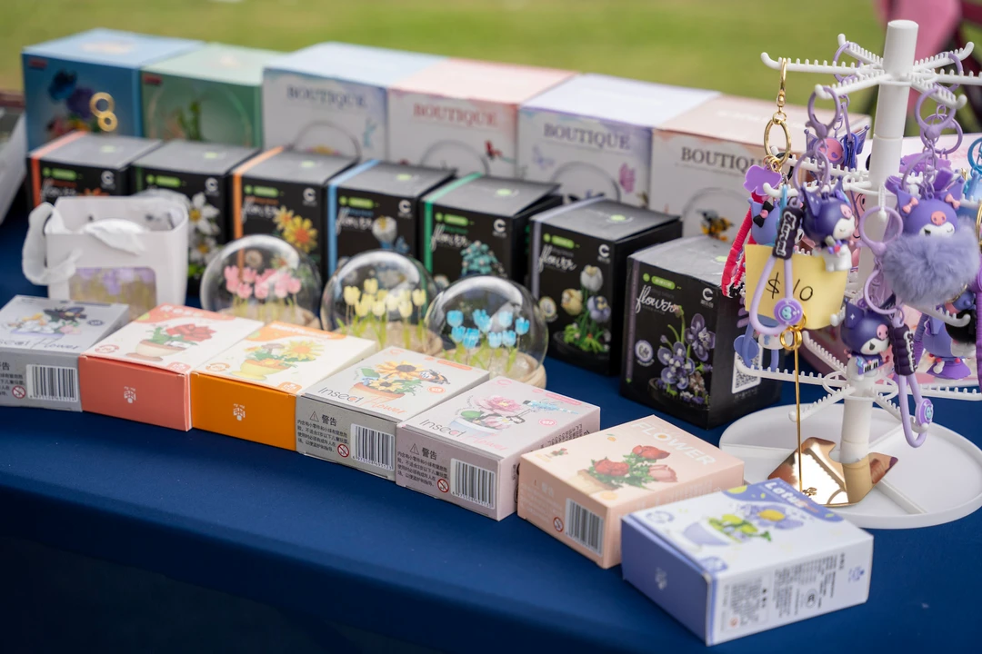 Colorful accessories and panda figures arranged on a market table.