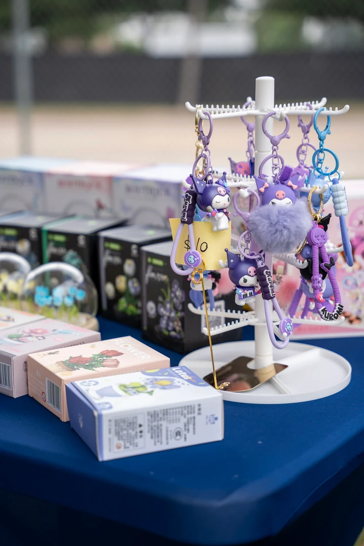 Colorful accessories and panda figures arranged on a market table.