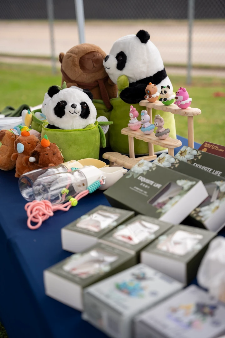Colorful accessories and panda figures arranged on a market table.