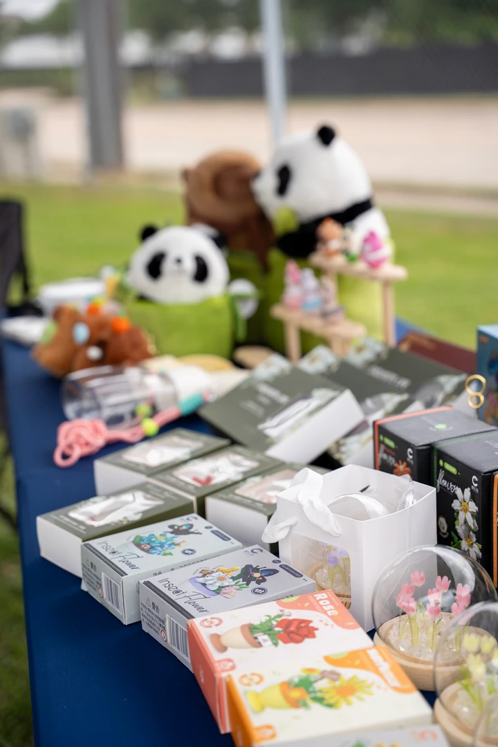Colorful accessories and panda figures arranged on a market table.