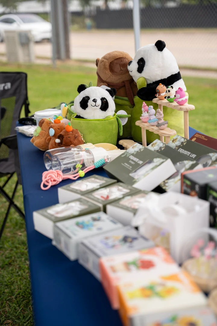Colorful accessories and panda figures arranged on a market table.