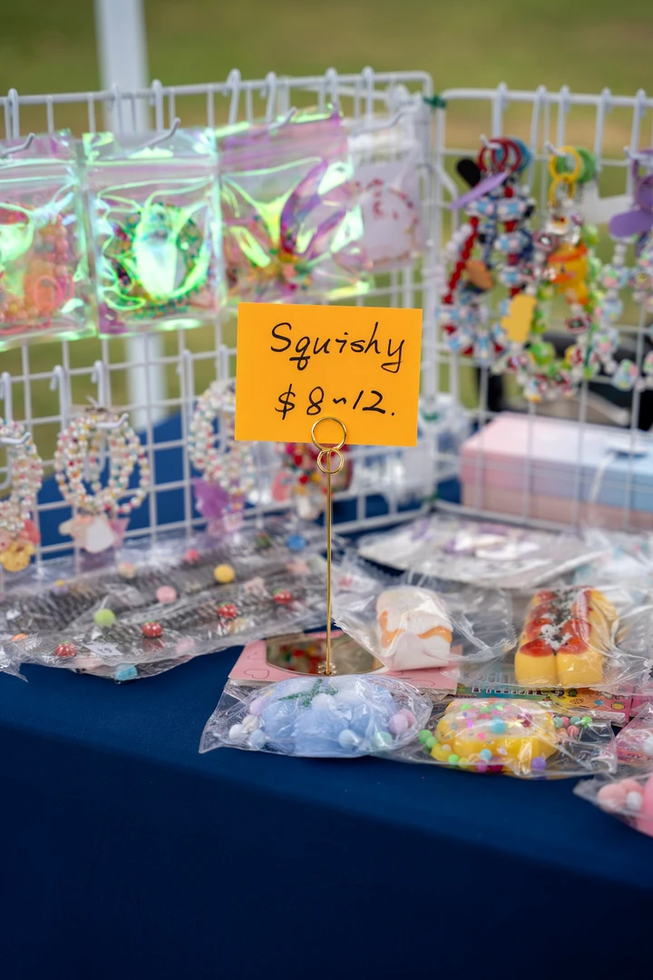 Colorful accessories and panda figures arranged on a market table.