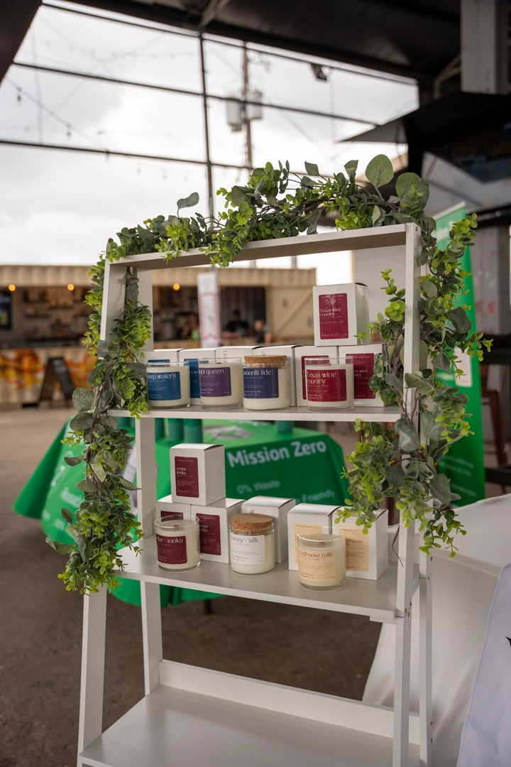 Candles and greenery arranged at a Vibe and Glo market stall.