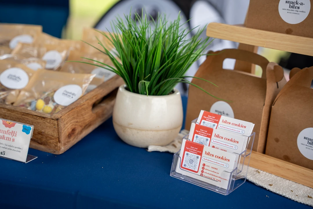 Packaged cookies and a printed menu on a blue-covered table.