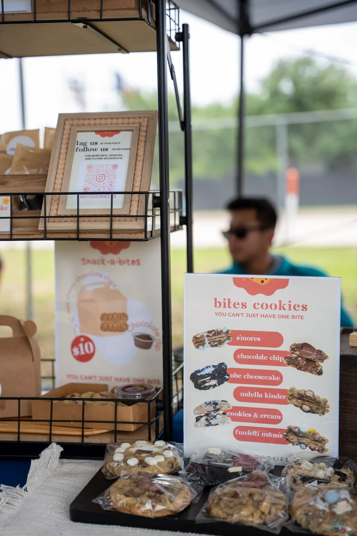 Packaged cookies and a printed menu on a blue-covered table.