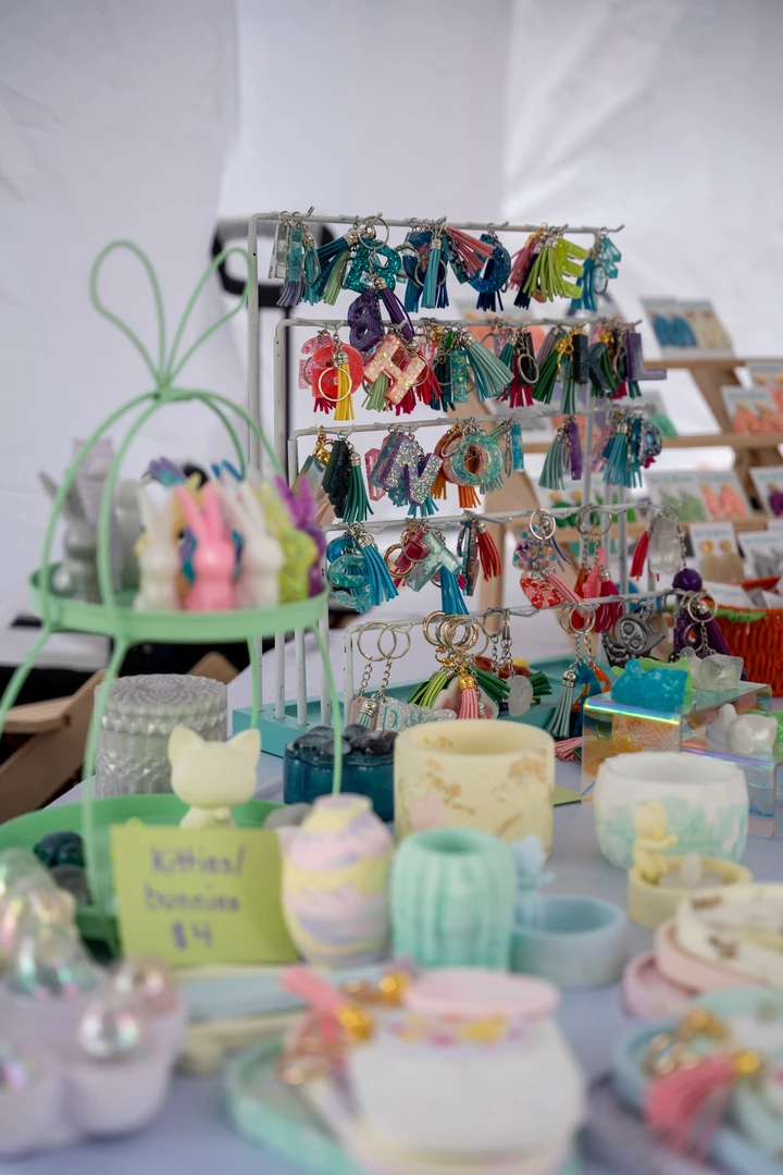 Pastel cups and small accessories arranged on a market table.
