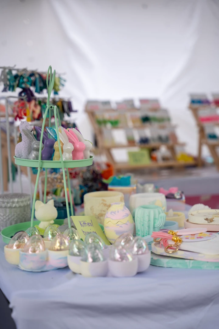 Pastel cups and small accessories arranged on a market table.