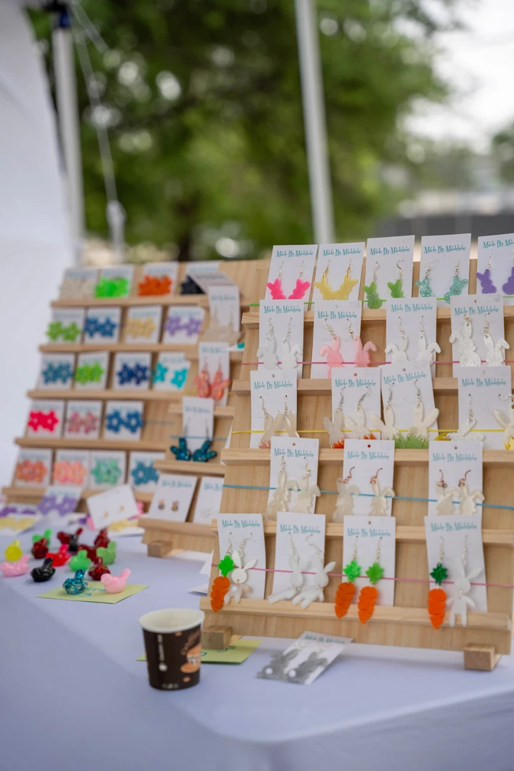 Rows of colorful earrings on a tiered display.