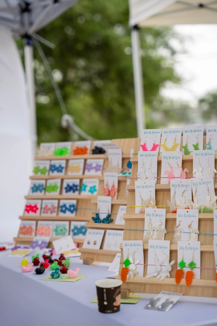 Rows of colorful earrings on a tiered display.