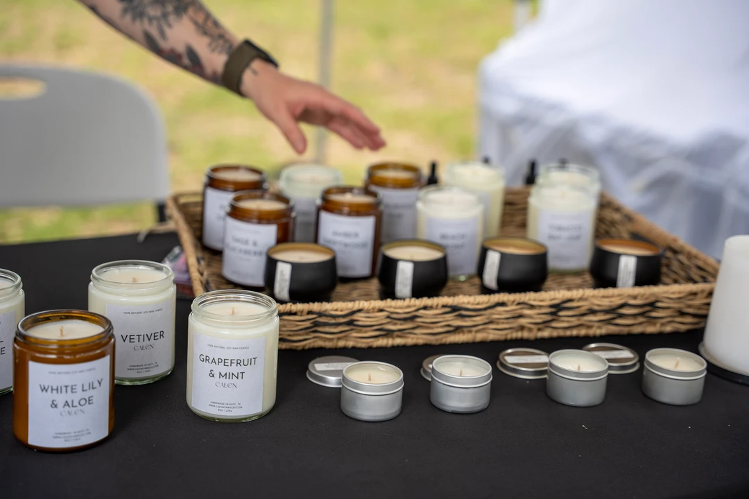 Small glass jars arranged in baskets on a dark tablecloth.