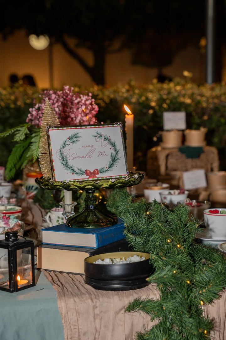 Flowers, greenery and small candles filling a market table.