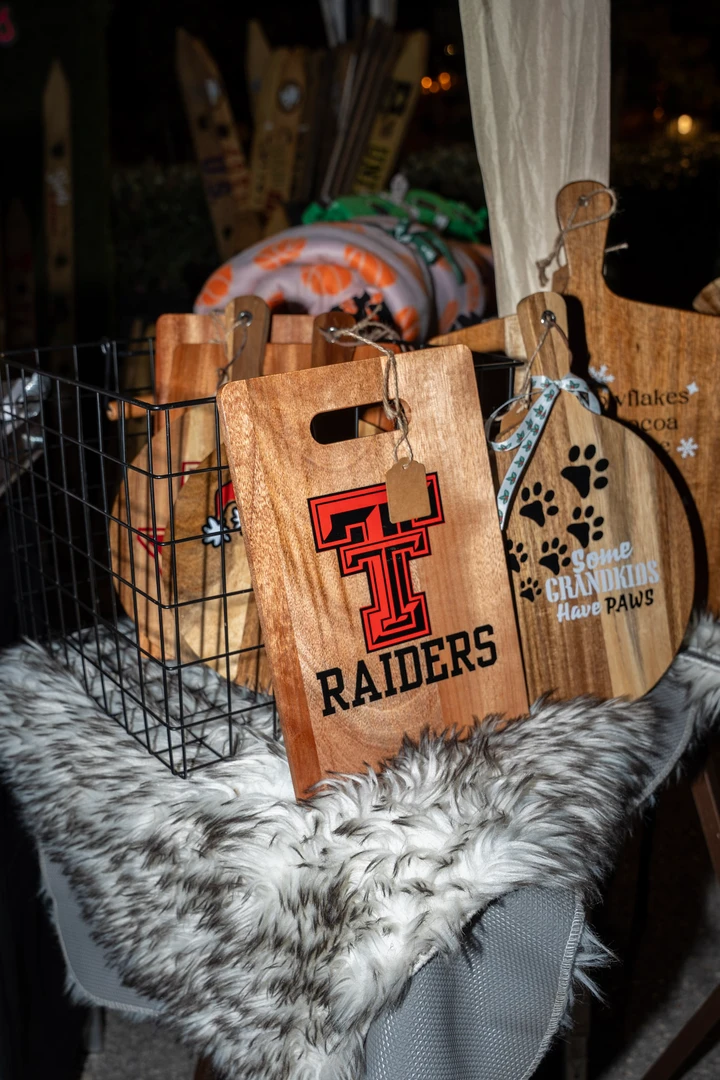 Decorated shot skis and wooden gifts at a market stall.