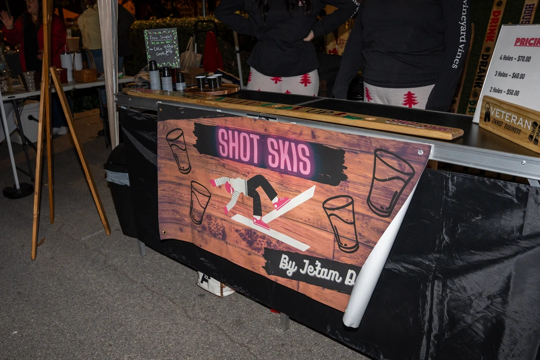 Decorated shot skis and wooden gifts at a market stall.
