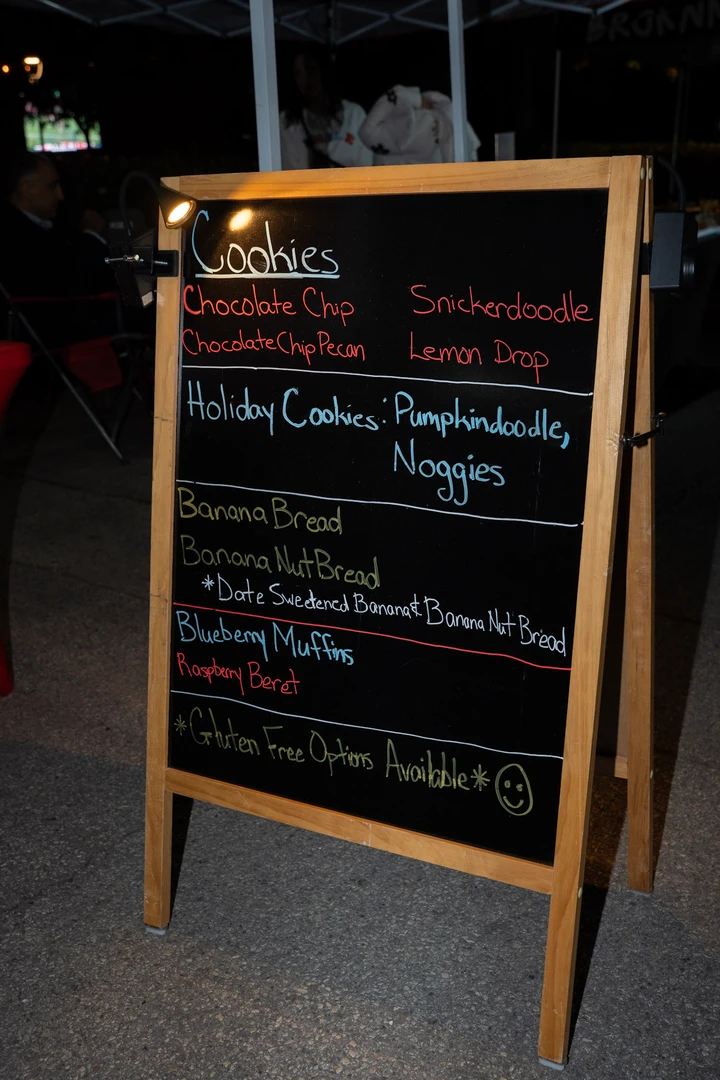 A handwritten baked-goods menu on an outdoor chalkboard.